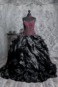 Alternative bride gown showcasing a richly decorated corset bodice, swirling beadwork details and a striking black Victorian silhouette