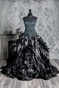 Black Victorian dress featuring a dramatic cascading skirt and an ornate blue beaded corset bodice, combining gothic elegance with alternative wedding fashion