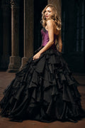 Woman wearing a purple corset gown with dramatic black ruffle skirt, Victorian dress inspired alternative bride aesthetic in a gothic setting