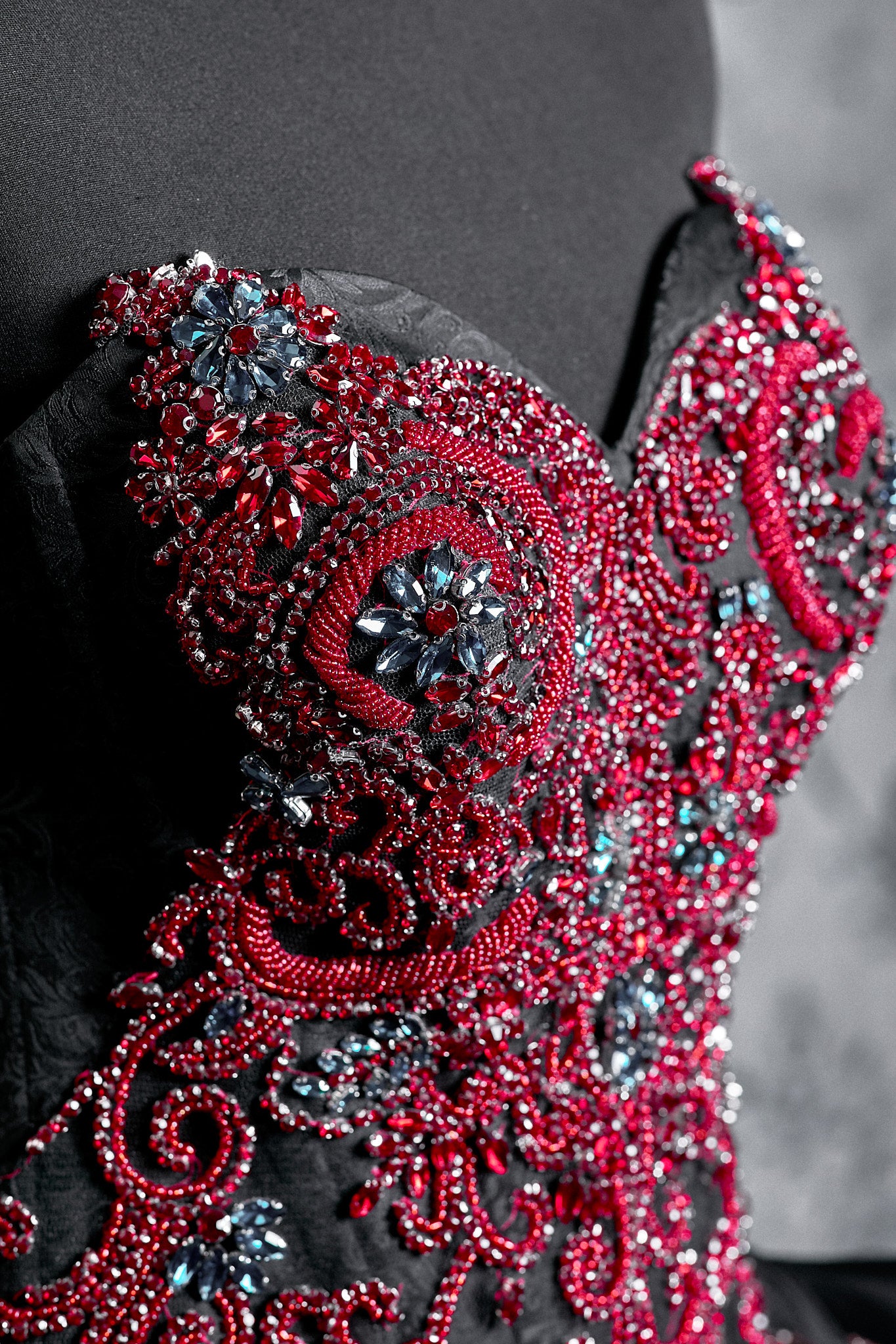 Intricately embroidered red corset gown with crystal embellishments and a voluminous black skirt inspired by Victorian dress design and gothic wedding style