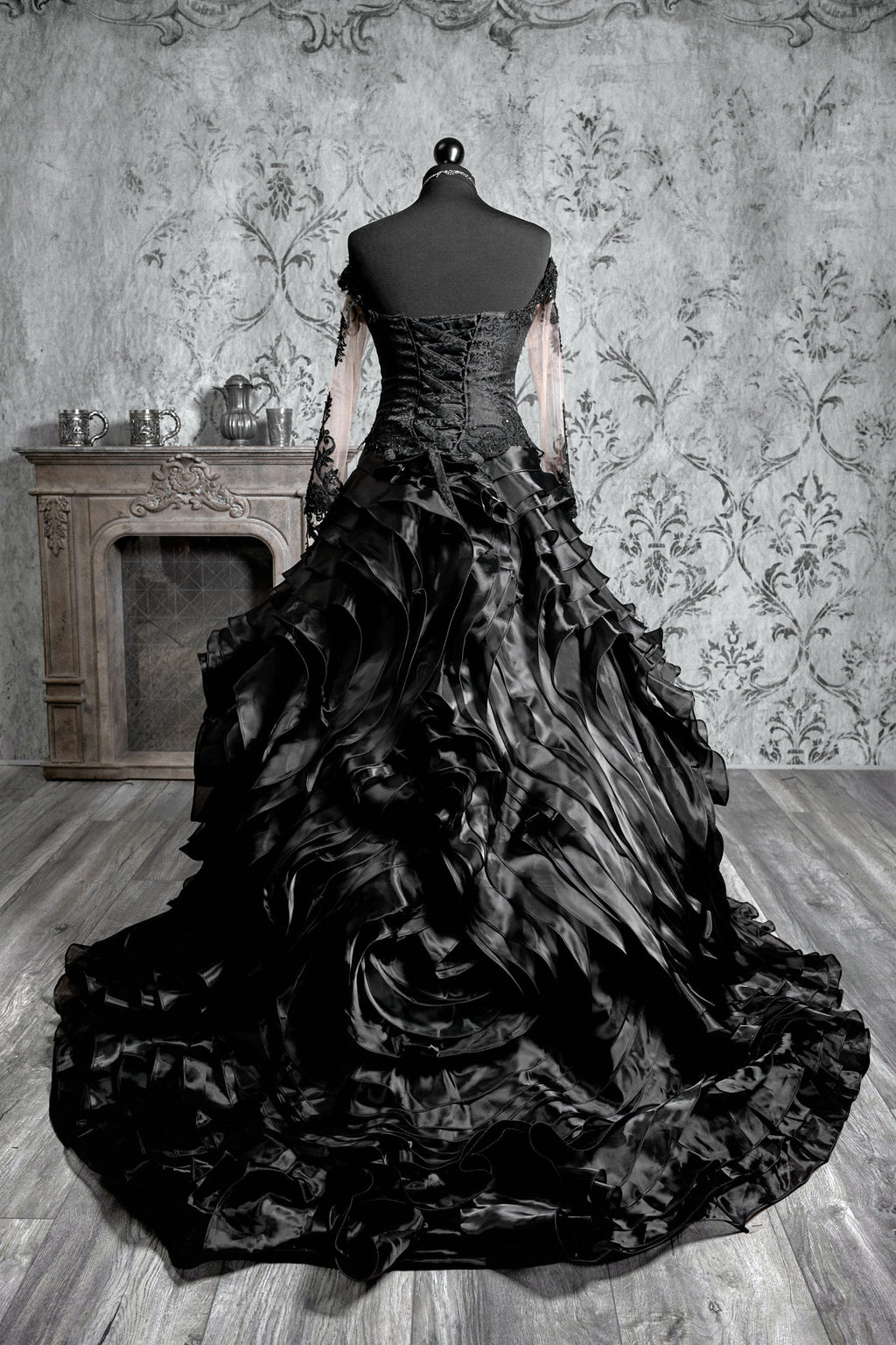 Back view of black gothic wedding ballgown with dramatic glitter tulle skirt, scattered lace appliqué throughout and sweeping cathedral train