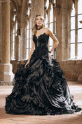 Black gothic wedding ballgown with strapless sheer front lace-up corset, beaded lace appliqué bodice and voluminous tiered organza ruffle skirt with cathedral train