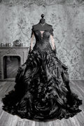 Black gothic wedding ballgown with sheer illusion long sleeves, sweetheart lace bodice and voluminous glitter tulle skirt with lace appliqué and cathedral train