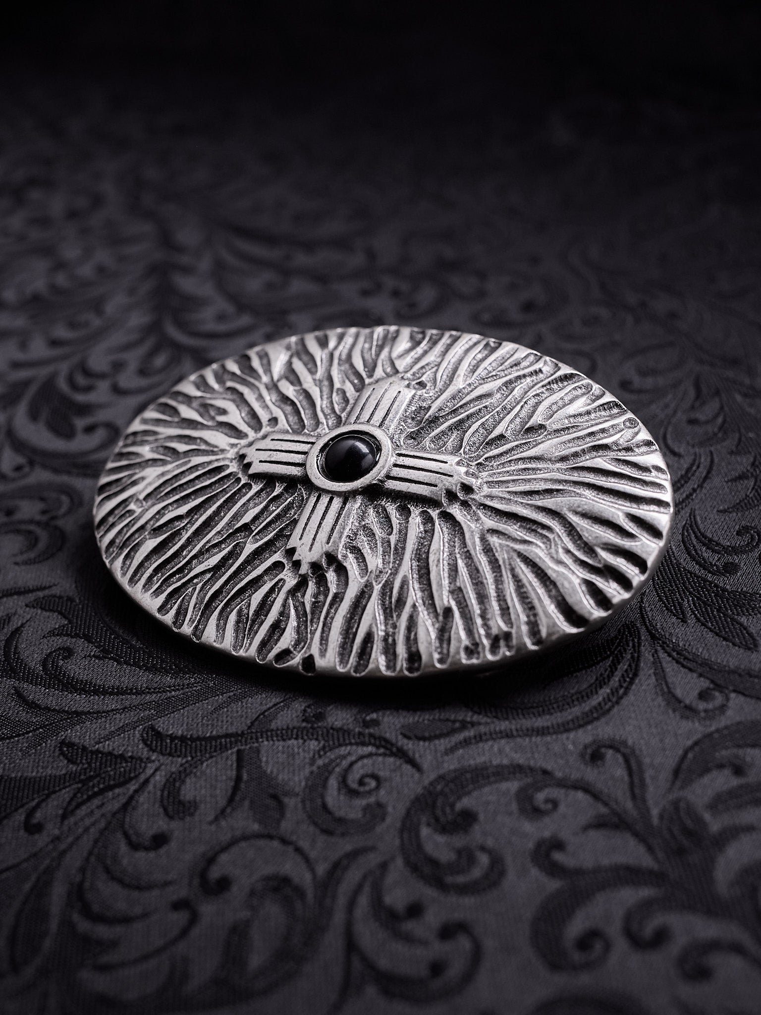 Detailed close-up of the weathered silver-tone finish and intricate metalwork on the Black Halo belt buckle