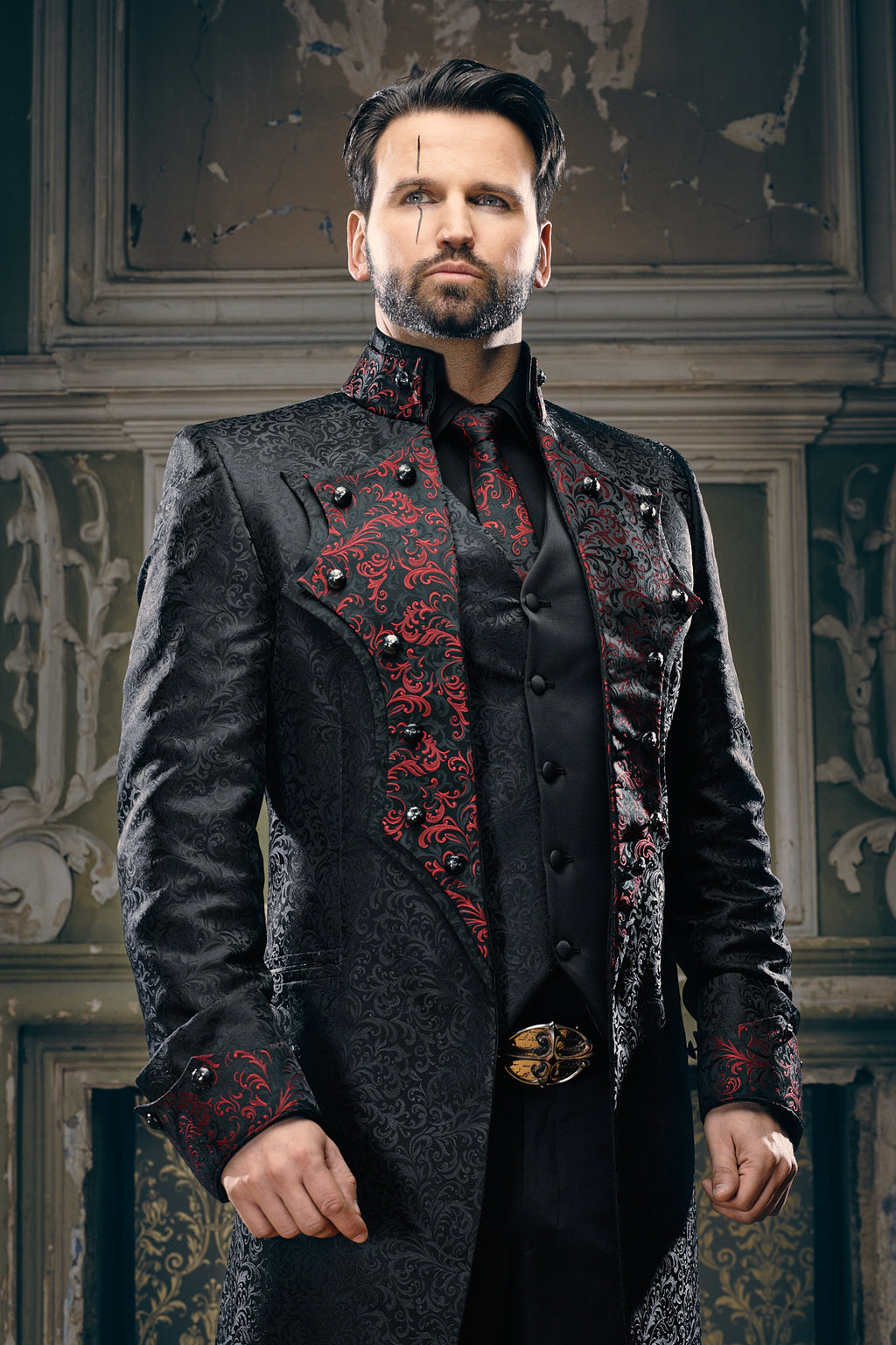 Close-up of red and black baroque scroll brocade lapel panel with black jewelled buttons and ornate collar detail on men's gothic frock coat