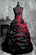 Black and red gothic wedding ballgown with strapless brocade corset, diagonal flame-shaped red appliqué cascading across ruched taffeta skirt with black fabric roses