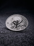 Detailed macro shot of the ornate flower patterns and the weathered silver-tone surface of the Corsair Oath buckle
