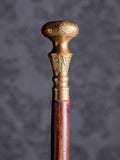 Detailed close-up of the Royal Classic cane handle, highlighting the intricate floral engravings and the warm metallic finish