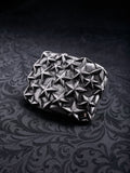 Rectangular metal belt buckle named Fallen Constellation with a dense pattern of raised 3D stars
