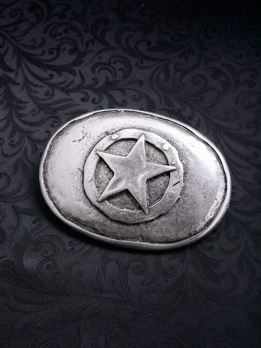 Oval metal belt buckle named Frontier Star with a central five-pointed star in a circle