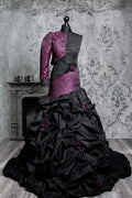 Gothic wedding ball gown with voluminous black jacquard skirt and magenta baroque pattern, asymmetric one-shoulder corset with long sleeve and cathedral train