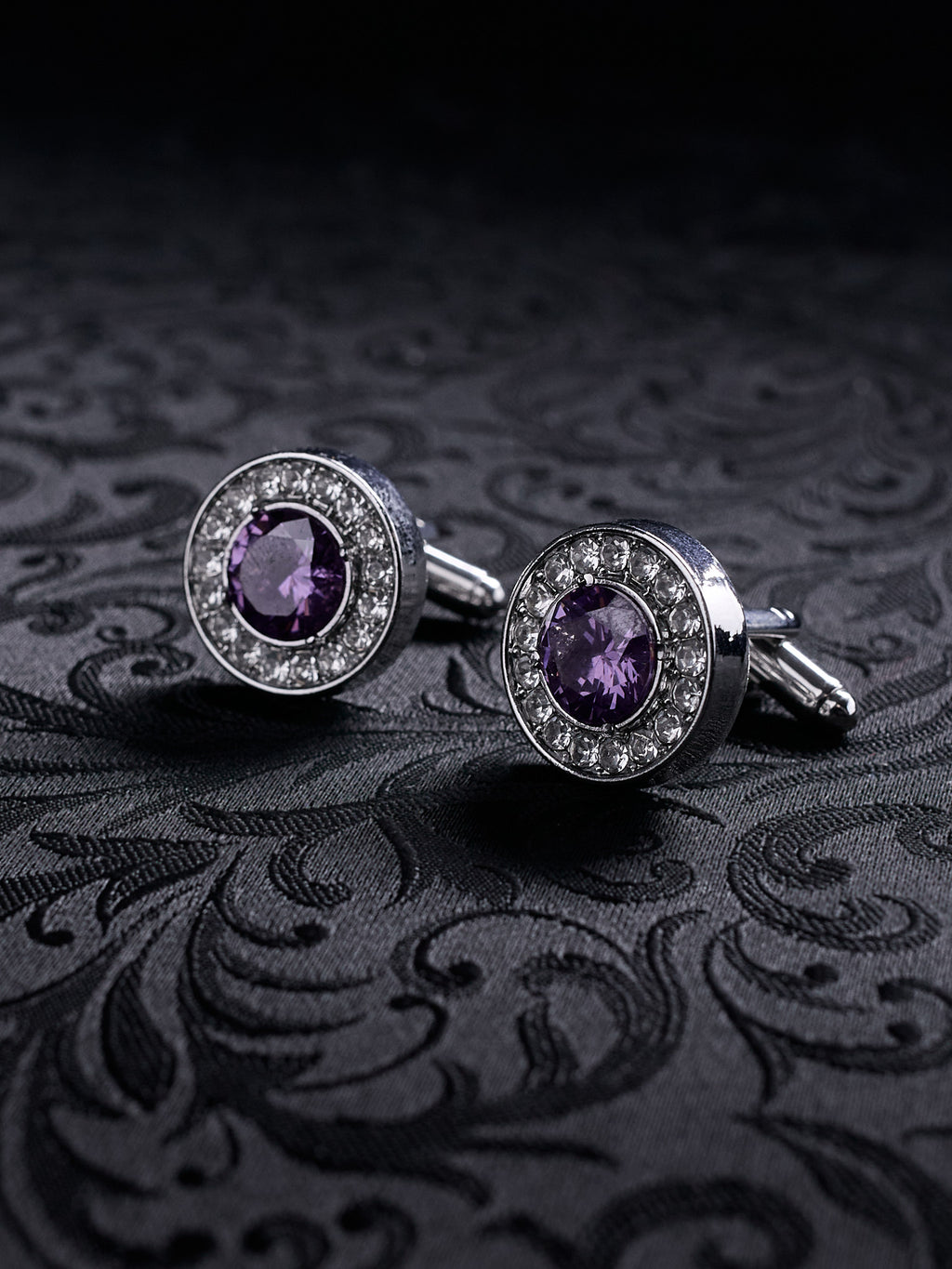Close-up of the Imperial Violet gothic cufflinks, showing the intricate metal settings and the deep purple gemstone sparkle.