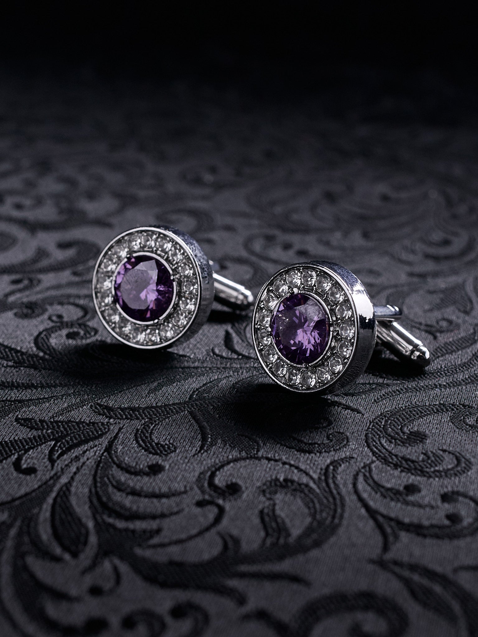 Close-up of the Imperial Violet gothic cufflinks, showing the intricate metal settings and the deep purple gemstone sparkle.