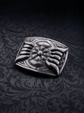Detailed shot of the raw grainy metal texture and oxidized silver finish on the Iron Bloom belt buckle