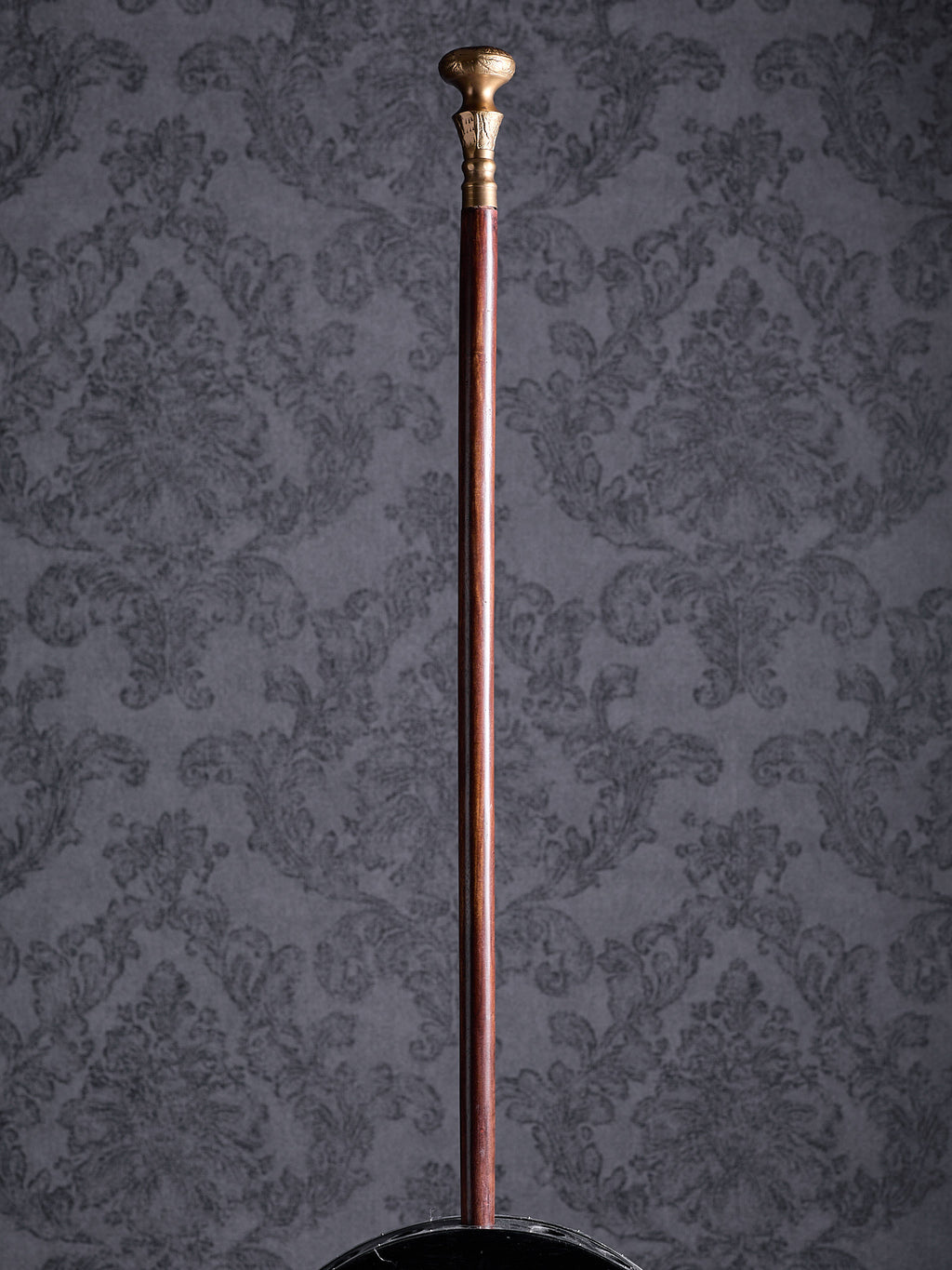 Full-length view of the Royal Classic cane with a brass-colored handle and polished mahogany-style shaft on a grey background