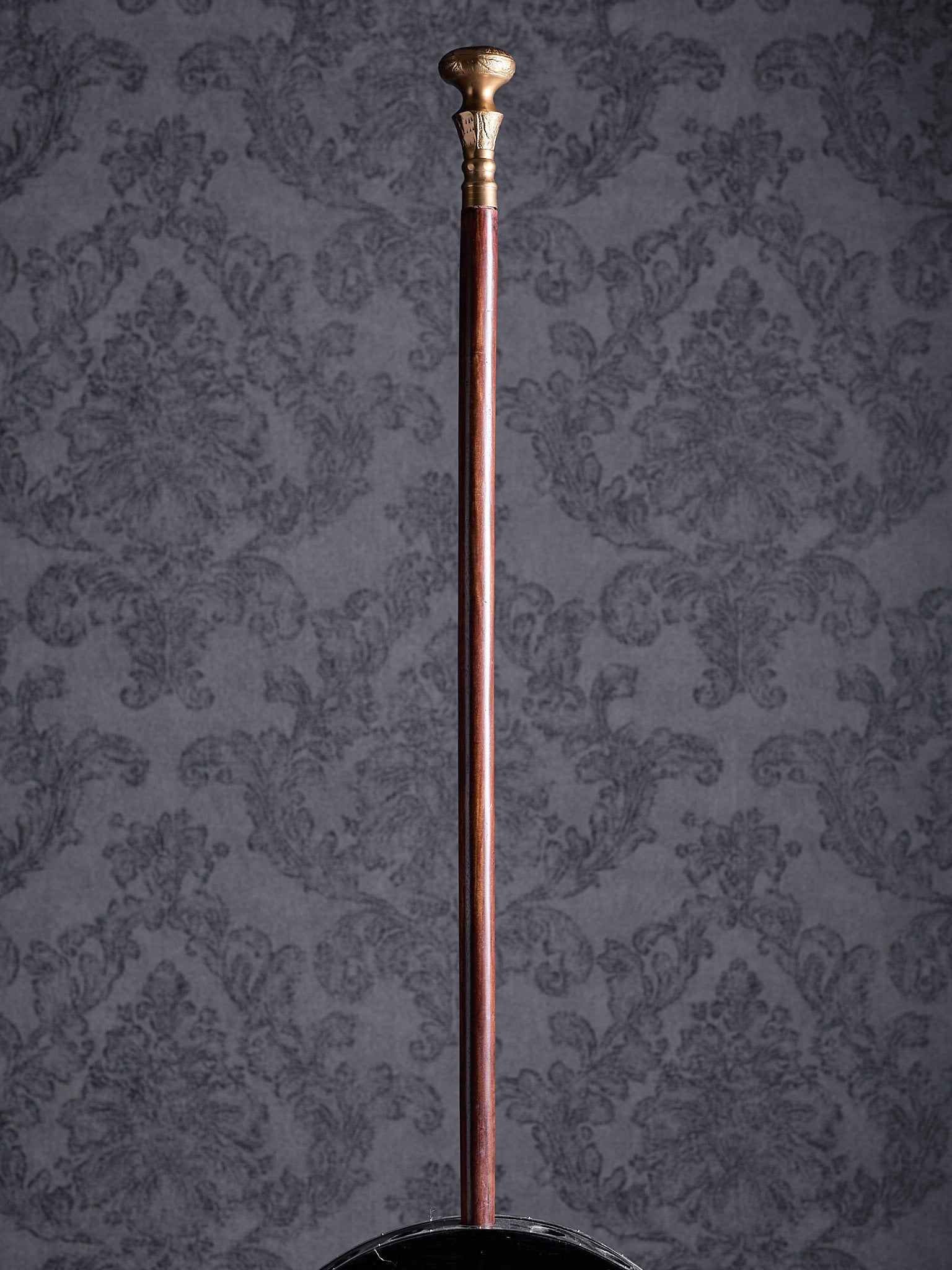 Full-length view of the Royal Classic cane with a brass-colored handle and polished mahogany-style shaft on a grey background